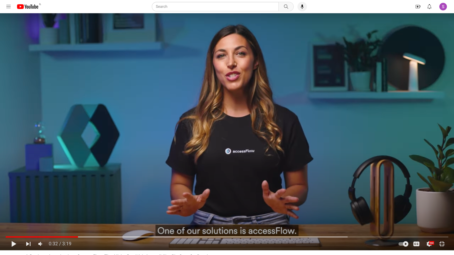 Video shot of a brunette women in an accessiBe shirt with captions at the bottom of the screen